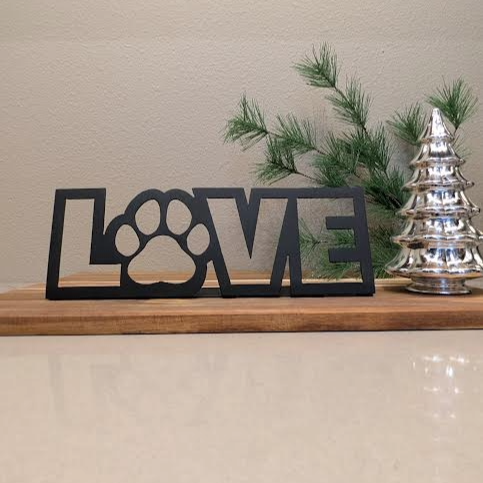 Image of a  black metal sign of the word "LOVE" and a paw for the "o" from Atomic Rat Rods & Metal Werks.