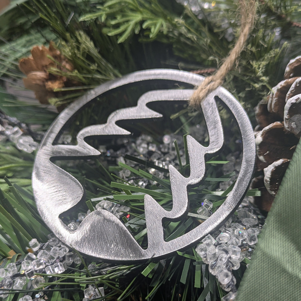 Simple, silver-colored, minimalist, metal tree ornament on a Christmas tree from Atomic Rat Rods & Metal Werks.