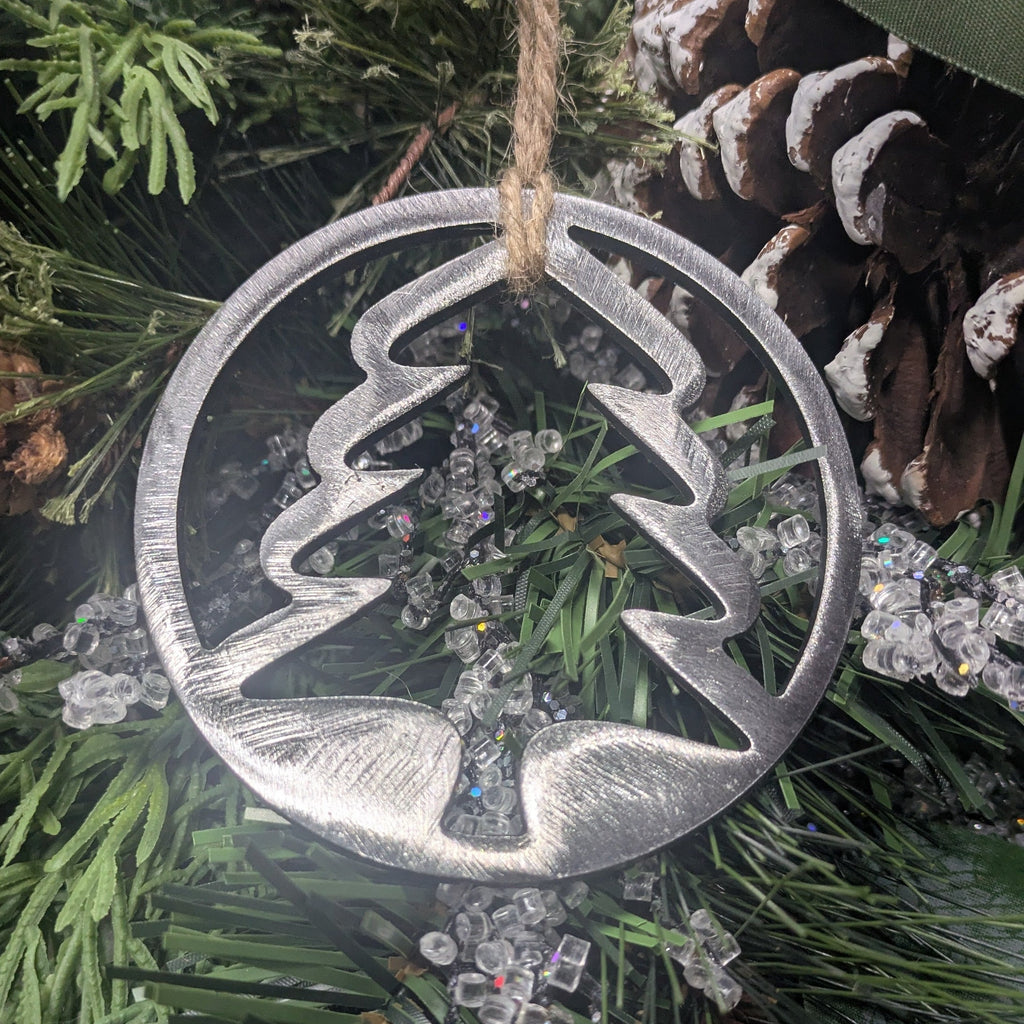 Simple, minimalist silver tree ornament on a Christmas tree from Atomic Rat Rods & Metal Werks.